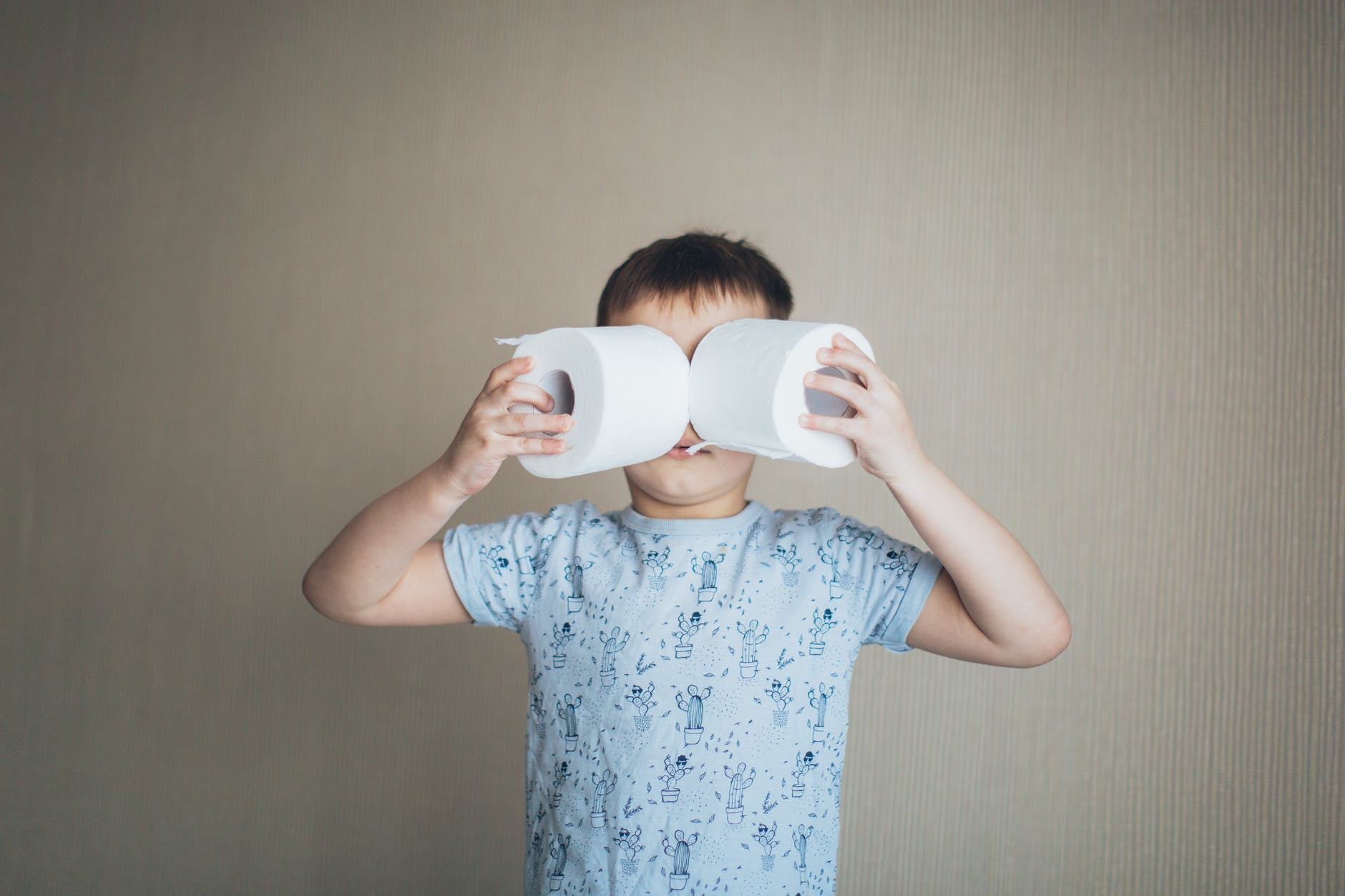 little boy holding tissue roll