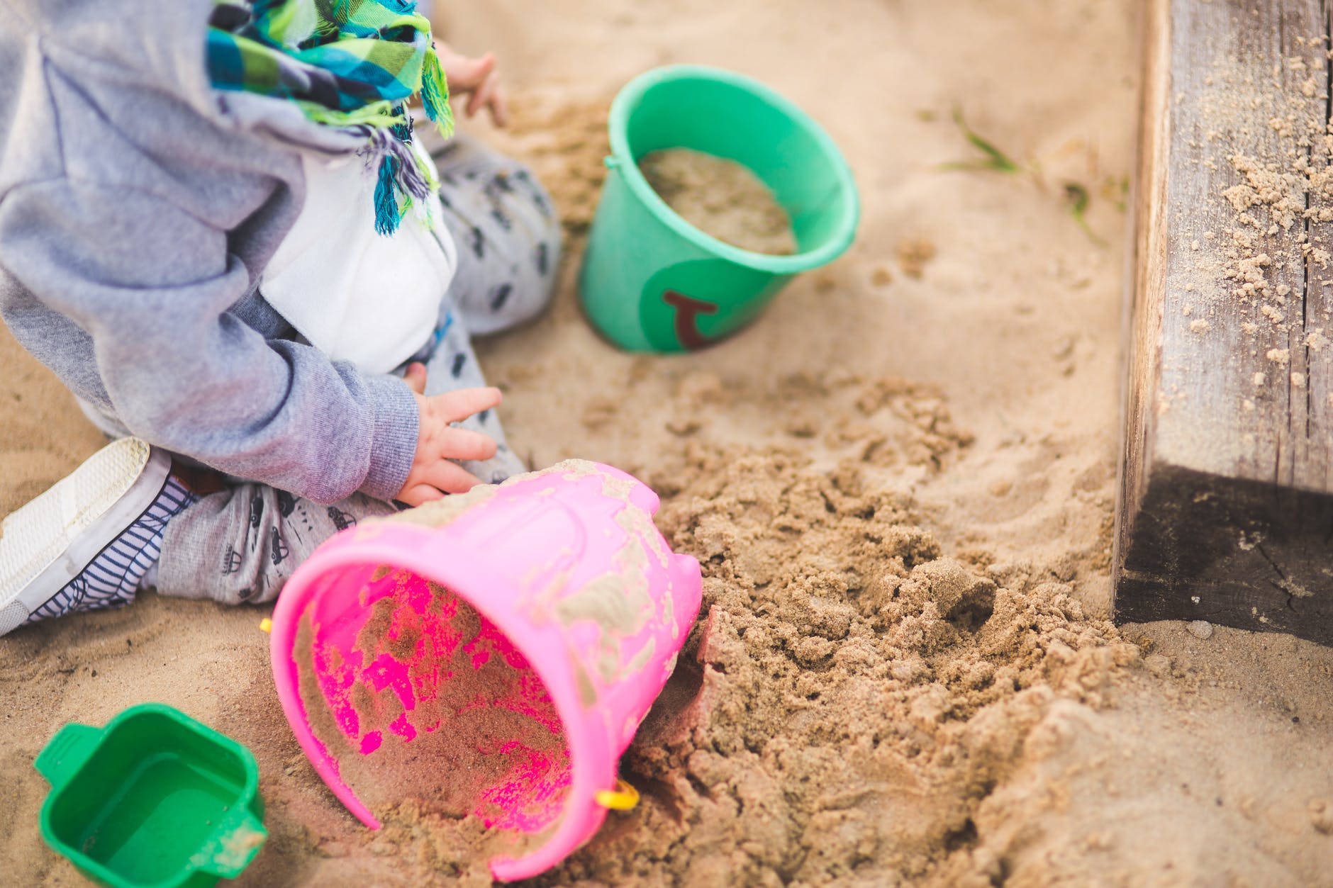 little boy playing in the sand